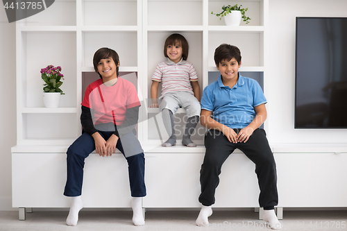 Image of young boys posing on a shelf