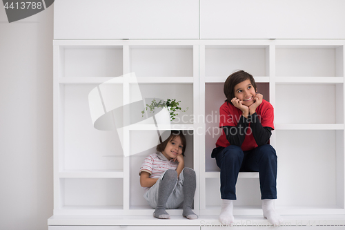 Image of young boys posing on a shelf