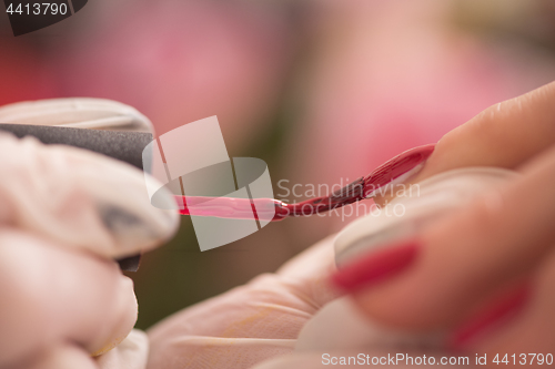 Image of Woman hands receiving a manicure