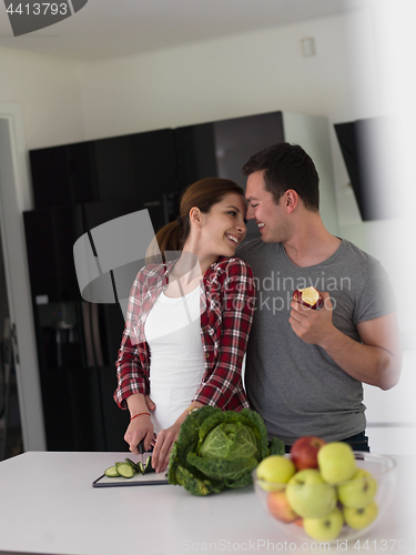 Image of Young handsome couple in the kitchen