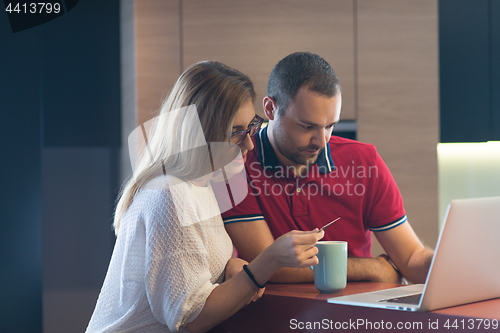 Image of happy young couple buying online