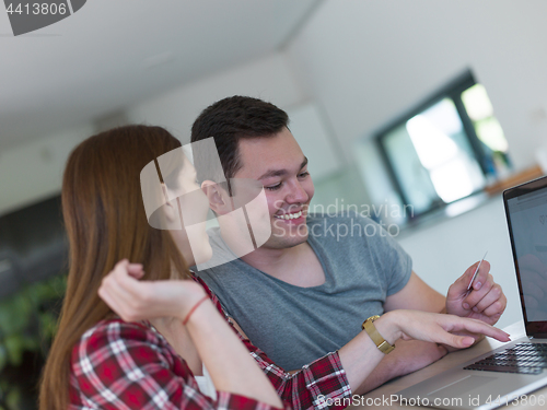 Image of happy young couple buying online