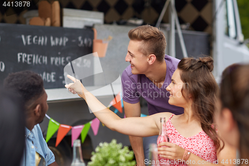 Image of happy customers or friends at food truck