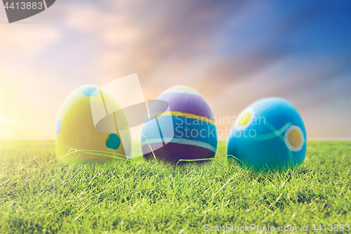 Image of close up of colored easter eggs on grass