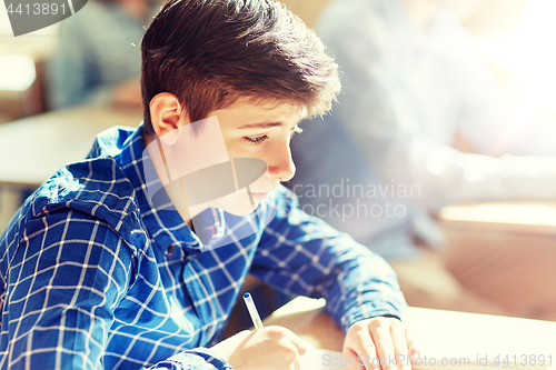 Image of group of students with books writing school test