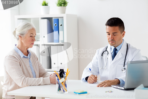 Image of woman and doctor with prescription at clinic