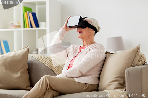 Image of old woman in virtual reality headset or 3d glasses