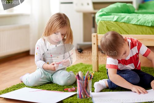 Image of happy kids drawing at home