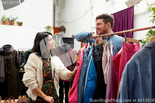 Image of happy couple at vintage clothing store hanger