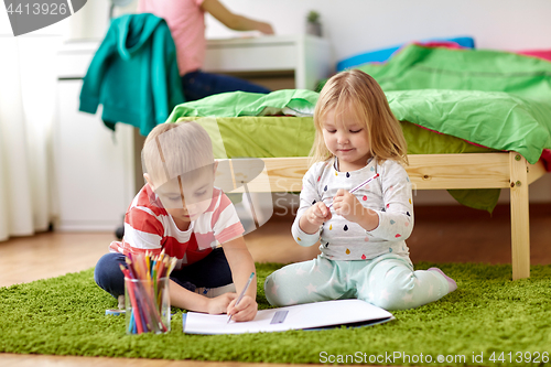 Image of happy kids drawing at home