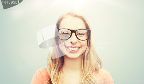 Image of happy young woman or teenage girl in eyeglasses