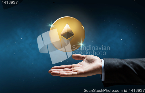 Image of businessman hand with etherum over space