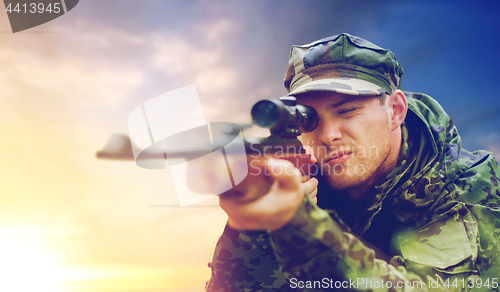 Image of soldier or hunter with gun aiming and shooting