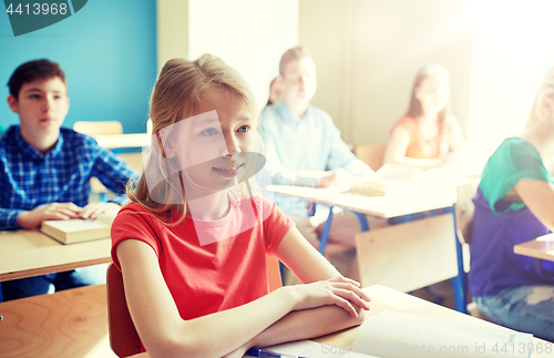 Image of happy student girl at school lesson