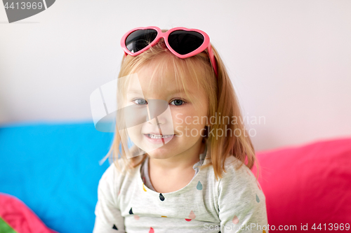 Image of portrait of smiling little girl with sunglasses