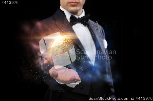 Image of male magician with planet and space hologram