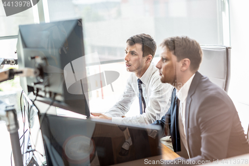 Image of Business team analyzing data at business meeting.