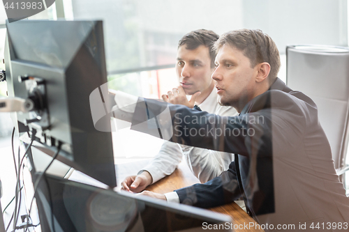 Image of Business team analyzing data at business meeting.