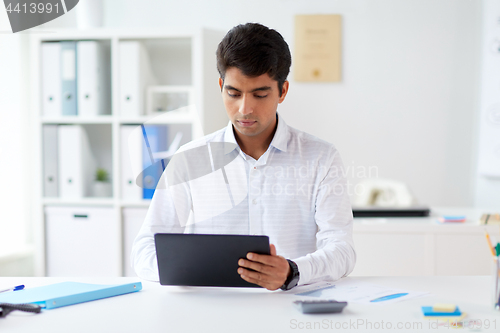 Image of businessman working with tablet pc at office