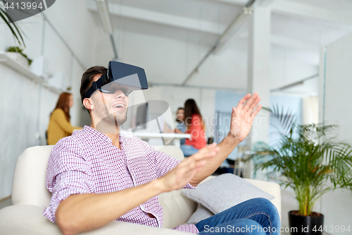 Image of happy man with virtual reality headset at office