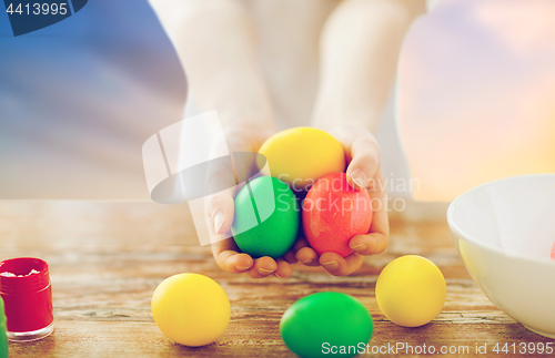 Image of close up of girl holding colored easter eggs