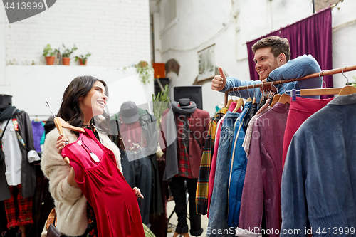 Image of couple choosing clothes at vintage clothing store