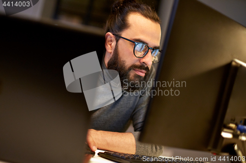 Image of close up of creative man working at night office