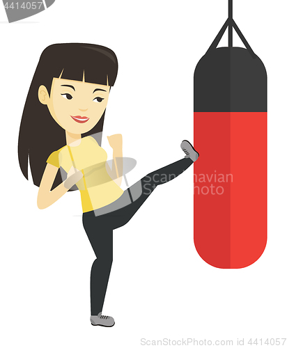 Image of Woman exercising with punching bag.