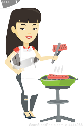 Image of Woman cooking steak on barbecue grill.