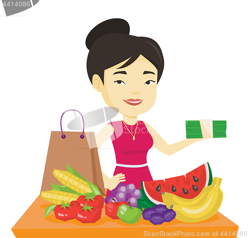 Image of Woman standing at the table with shopping bag.