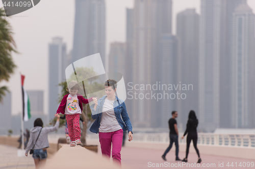 Image of mother and cute little girl on the promenade