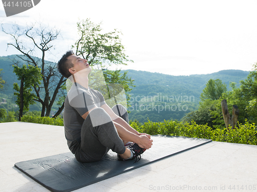 Image of man doing morning yoga exercises