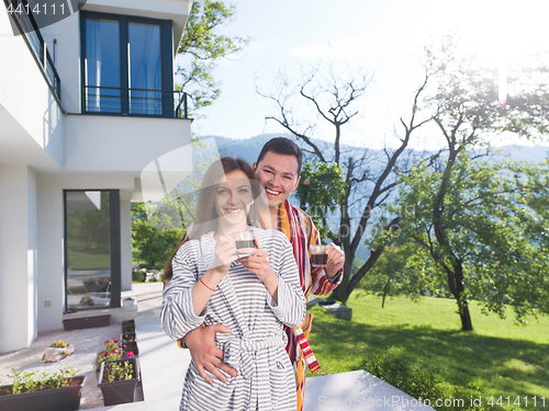 Image of Young beautiful couple in bathrobes