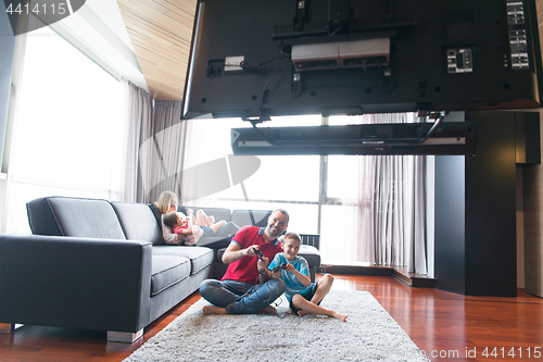 Image of Happy family playing a video game