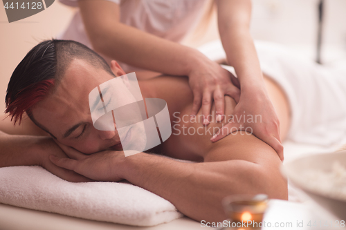 Image of young man having a back massage