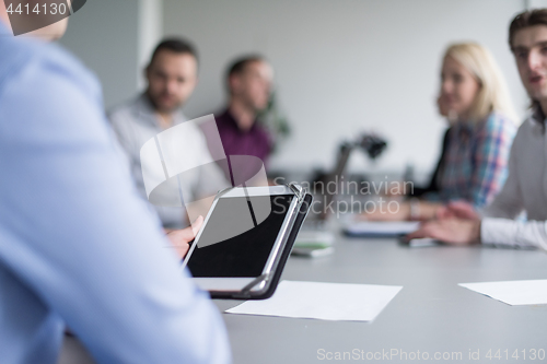 Image of Businessman using tablet in modern office