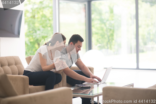 Image of happy young couple buying online