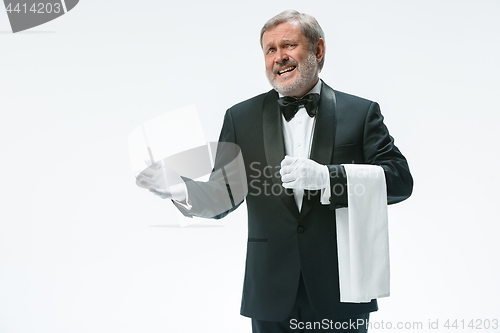 Image of Senior waiter holding white towel