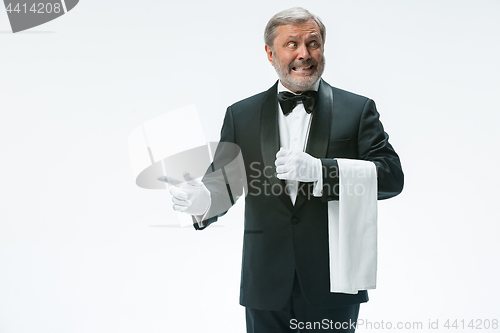 Image of Senior waiter holding white towel