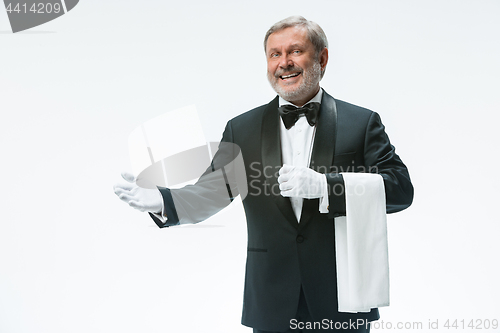 Image of Senior waiter holding white towel