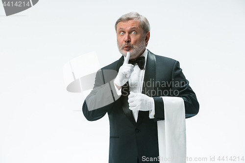 Image of Senior waiter holding white towel