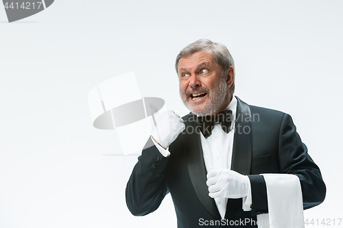 Image of Senior waiter holding white towel