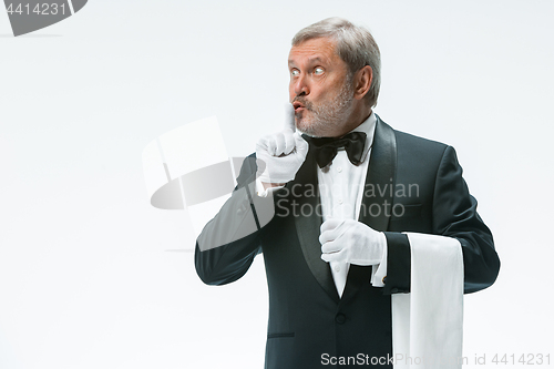 Image of Senior waiter holding white towel