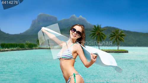 Image of woman in bikini and sunglasses on bora bora beach