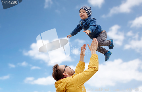 Image of father with son playing and having fun outdoors