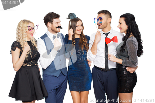 Image of happy friends with party props posing