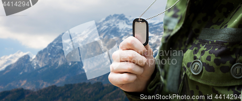 Image of close up of young soldier with military badge