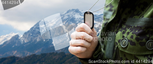 Image of close up of young soldier with military badge