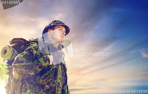 Image of soldier in military uniform with backpack hiking