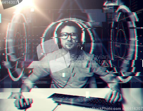 Image of man in headset with computer virtual projections